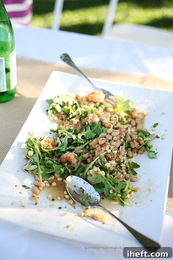 Shrimp, white bean, and corn salad over arugula