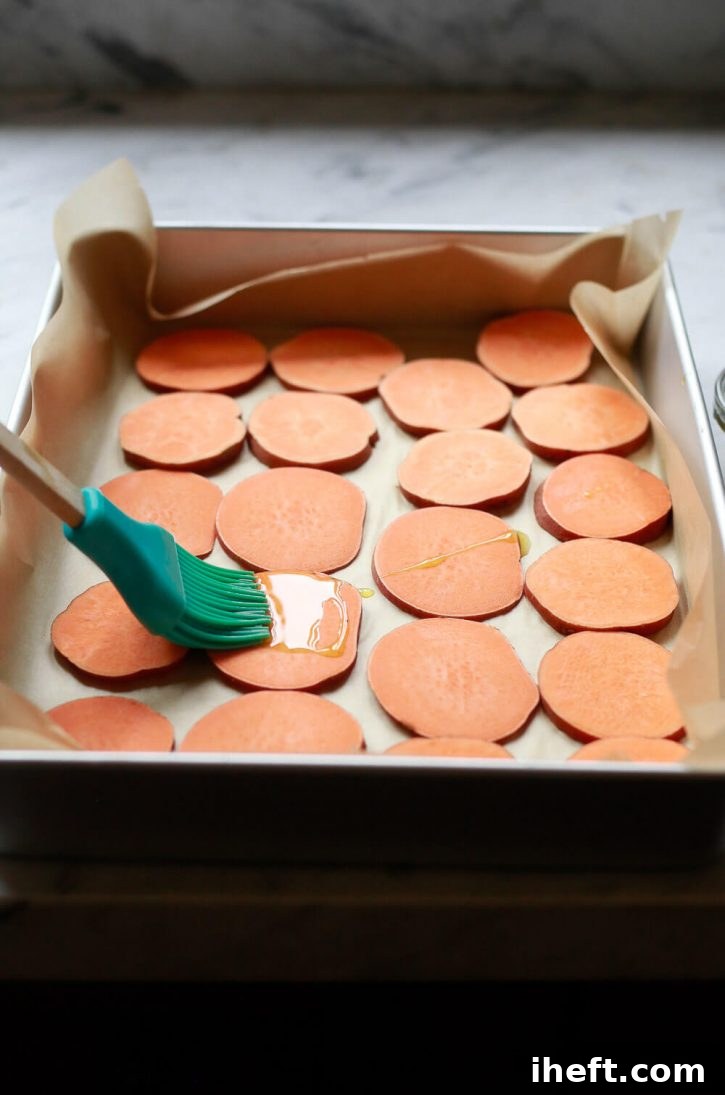 Sweet potato slices are brushed with olive oil before baking into sweet potato crostini, a healthy vegan appetizer. 
