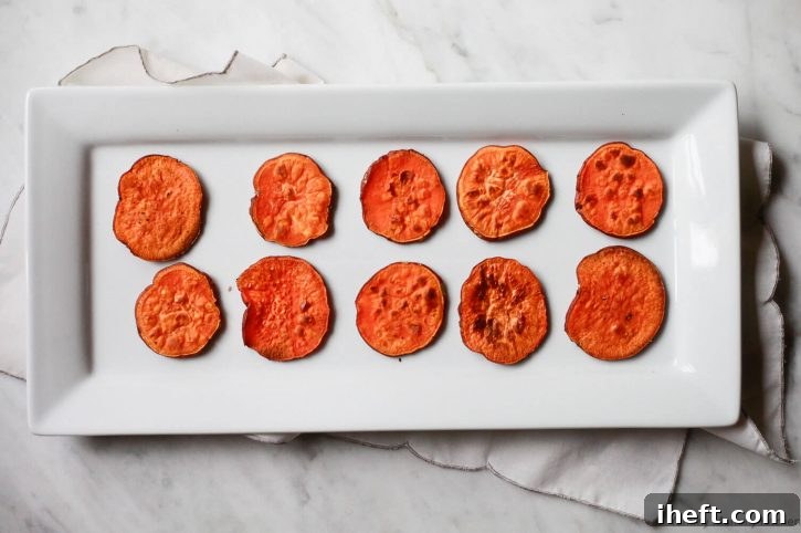 A tray filled with sweet potato toast rounds, or crostini, ready to be topped with avocado. 
