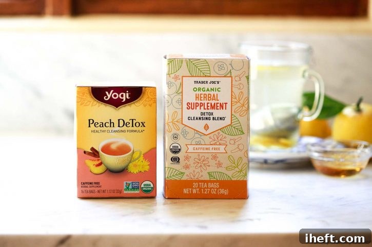 Boxes of Yogi Detox Tea and Trader Joe's Detox Cleansing Blend Tea on a white kitchen countertop. 