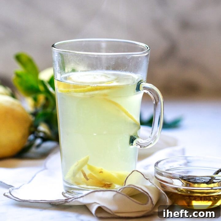 A glass tea cup filled with homemade detox tea made with dandelion root, ginger, and lemon.