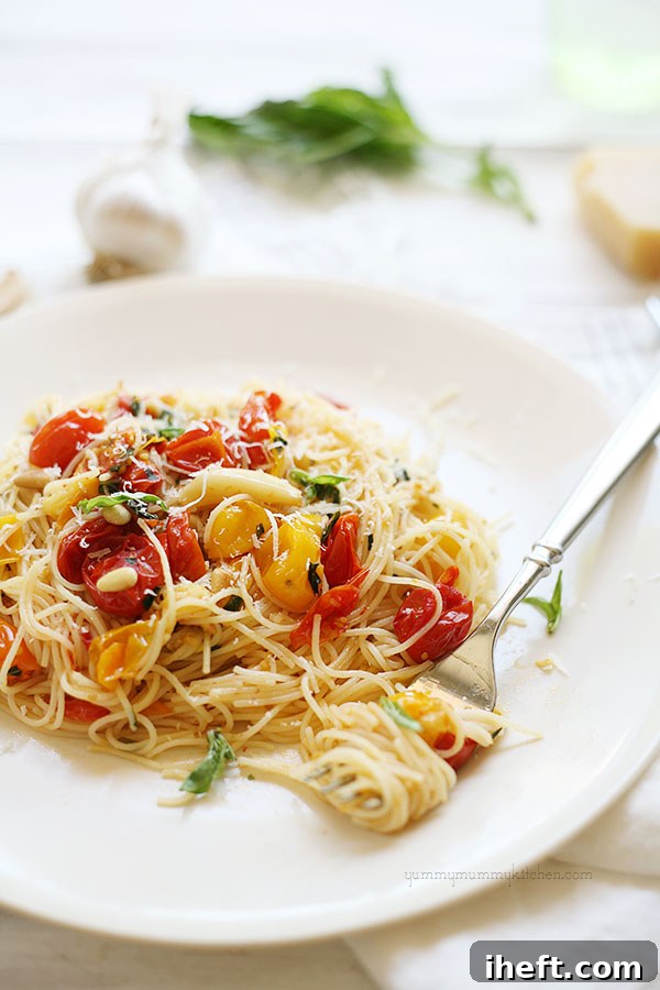 A bowl of Capellini pasta with roasted tomatoes and fresh basil, prepared for a vegetarian meal.