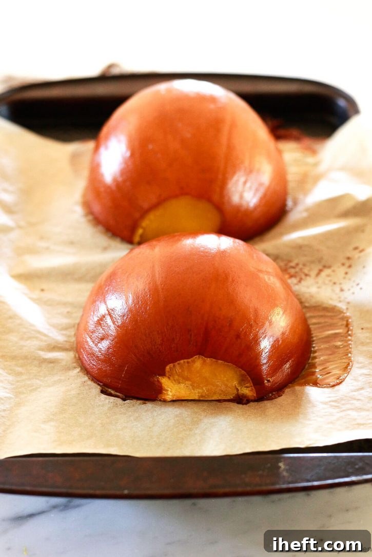 Pumpkin halves roasted on a baking sheet for making pumpkin puree. How to cook pumpkin. 