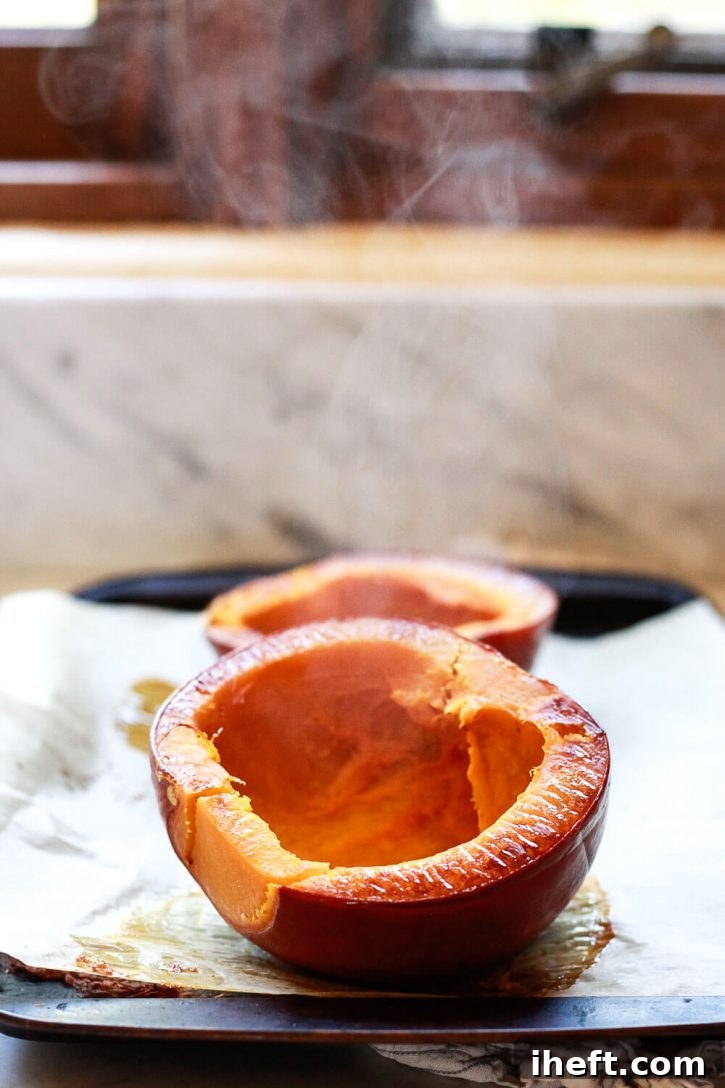 Steam comes off roast pumpkin halves on a baking sheet. How to cook pumpkin for pie. 
