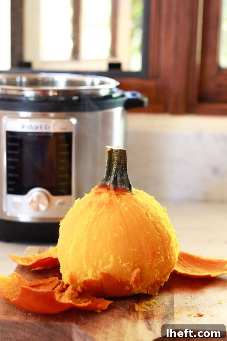 A whole pumpkin is peeled after cooking in the Instant Pot pressure cooker. Instant Pot pumpkin is an easy way to make pumpkin puree. 