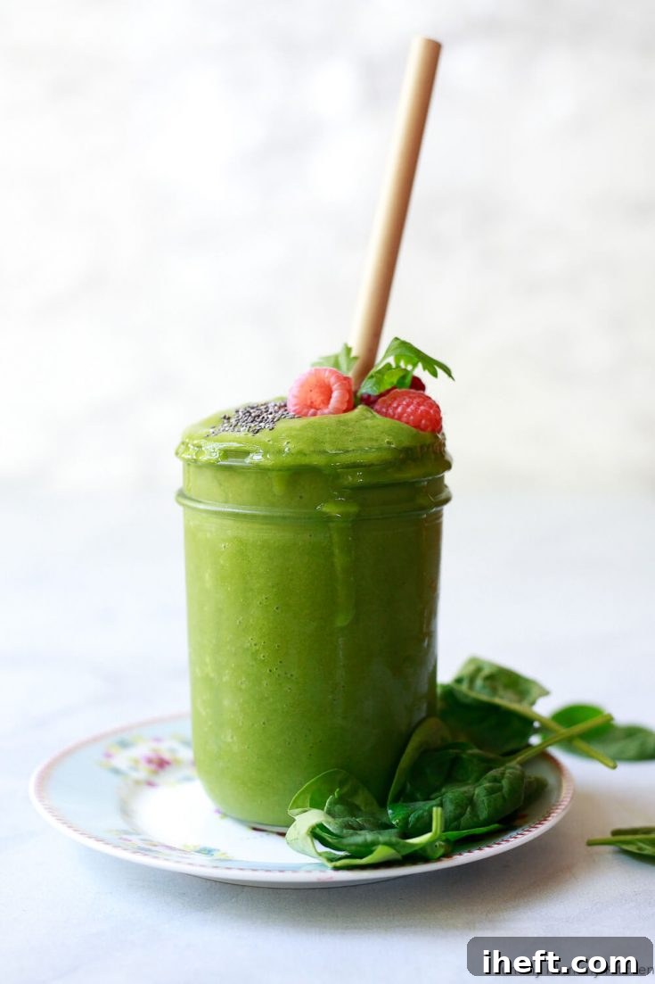 A vibrant glass of a superfood green detox smoothie, brimming with liver-supporting ingredients such as fresh spinach, crisp cucumber, hydrating coconut water, zesty ginger, sweet apple, and aromatic parsley.