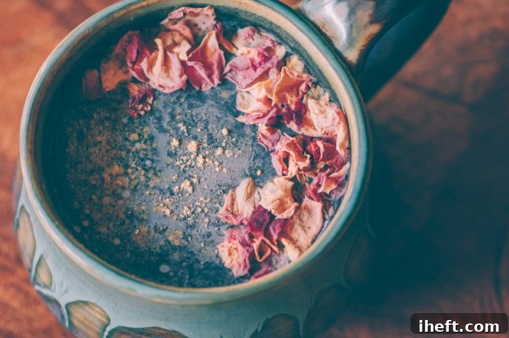 A beautifully crafted Cosmic Ginger Rose Activated Charcoal Latte, presented as an intriguing beverage for very occasional cleansing, with an important disclaimer about the daily use of activated charcoal.