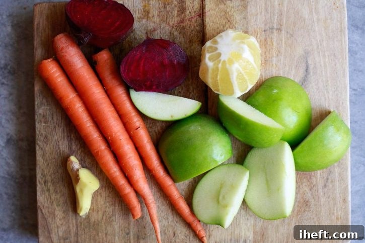 A close-up of the essential ingredients for making a revitalizing detox beet juice, neatly arranged on a wooden cutting board. Peeled ginger, vibrant red beets, crisp carrots, a bright yellow lemon, and a green apple are all prepped and ready for juicing, highlighting the natural freshness and purity of the recipe.