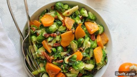 This vegan roasted Brussels sprouts salad is tossed with persimmons, pecans, and a maple vinaigrette.
