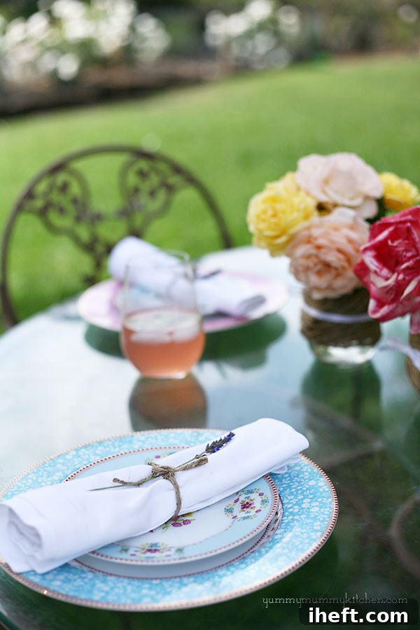 A close-up of a serving of heirloom tomato and greens lasagna on a decorative plate.