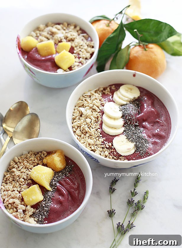 Three Acai superfood bowls topped with bananas, mango, and chia seeds.
