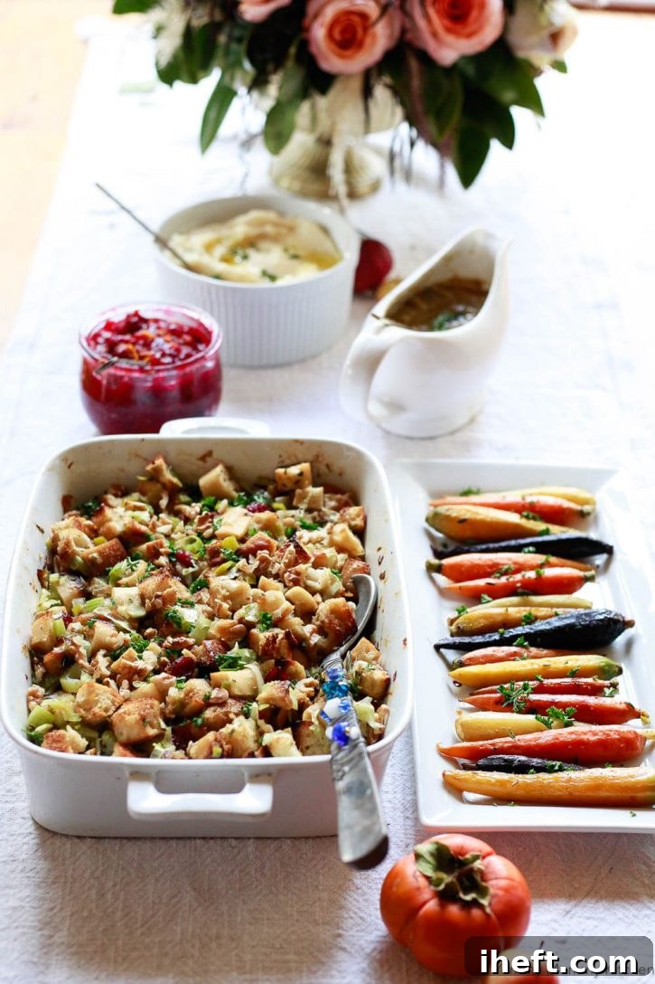 A vibrant and inviting holiday table setting, brimming with an assortment of delicious vegetarian and vegan dishes perfect for Thanksgiving or Christmas, including golden-brown vegan stuffing, rich cranberry sauce, savory vegan mushroom gravy, colorful roasted rainbow carrots, and creamy mashed cauliflower.
