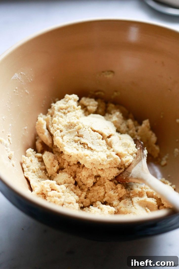 Masa dough for tamales is stirred together with a wooden spoon. 