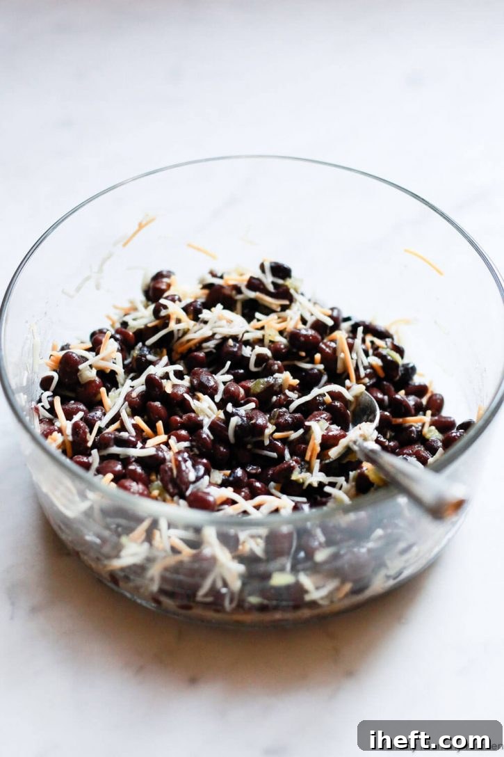 Black beans, vegan cheese, and green chiles are mixed together to make a vegan tamale filling. 