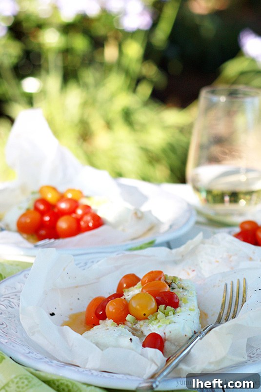 Parchment paper packets filled with halibut baked with cherry tomatoes and lemongrass. 