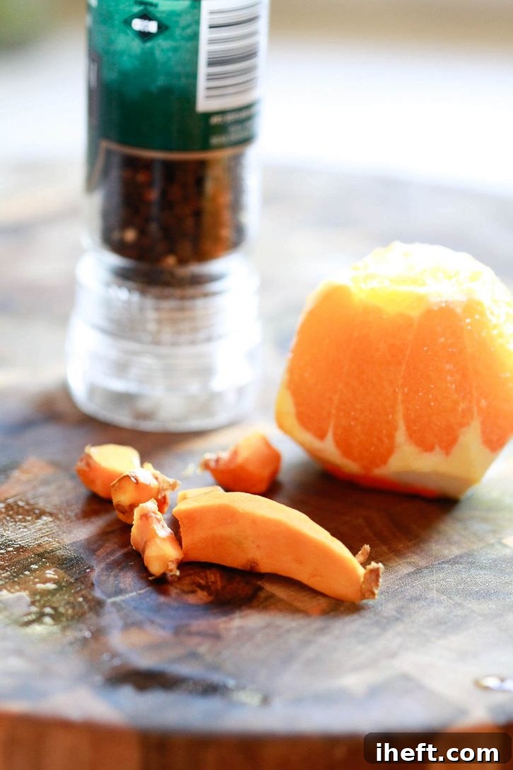 A close-up shot showcasing the beautiful texture of fresh turmeric root, highlighting its earthy, vibrant nature and readiness for juicing or blending into healthy concoctions.