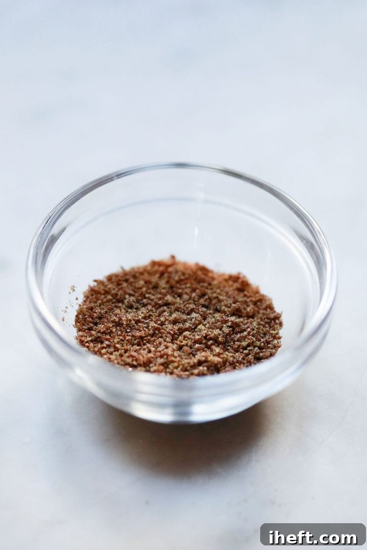 A small bowl filled with finely ground flax meal, perfectly prepared for making a vegan flax egg substitute.