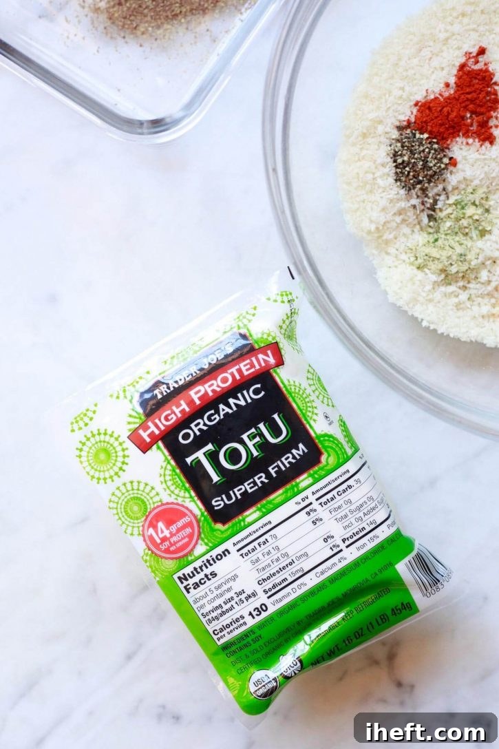 A block of Trader Joe's high protein organic super firm tofu sits on a countertop next to panko breadcrumbs for making tofu nuggets.