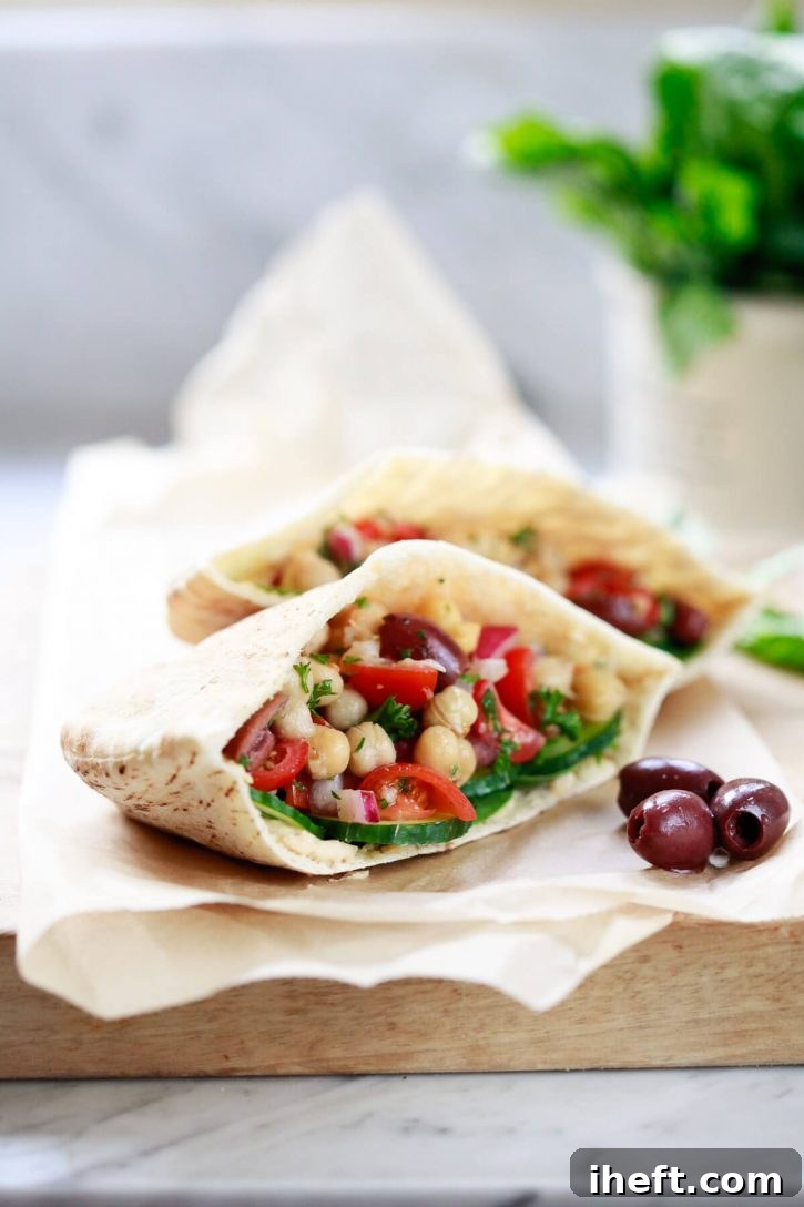 A vegan pita pocket generously filled with Balela bean salad, creamy hummus, and crisp cucumber slices. Balela makes a delicious and healthy meal prep recipe, perfect for a vegetarian or vegan lunch on the go.