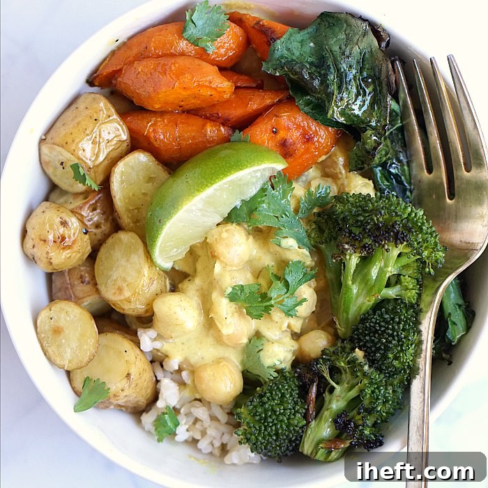 A rich and vibrant yellow curry with chickpeas and roasted vegetables, served over rice.