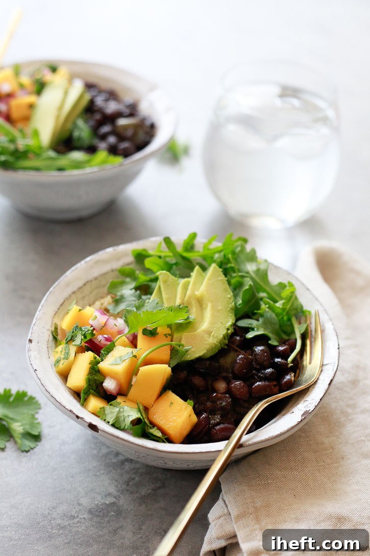 A bowl of flavorful Cuban black beans, garnished with fresh cilantro and a lime wedge.