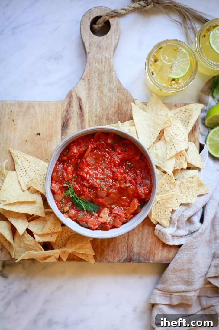 A bowl of homemade chipotle salsa roja with chips. 