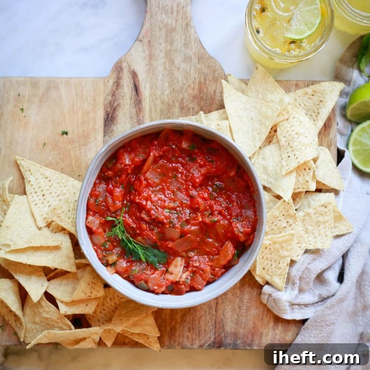 A vibrant bowl of Homemade Chipotle Salsa Roja, perfectly complemented by crisp tortilla chips, showcasing the rich colors and textures of this easy-to-make cooked salsa.