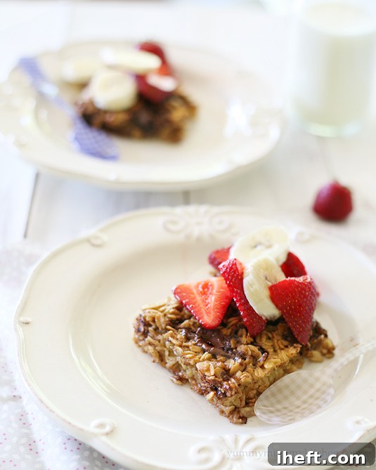 Nutella Baked Oatmeal on white ceramic plates with strawberries.