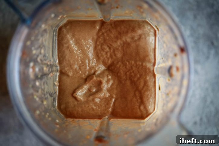 A chocolate smoothie just blended inside a Vitamix blender. 