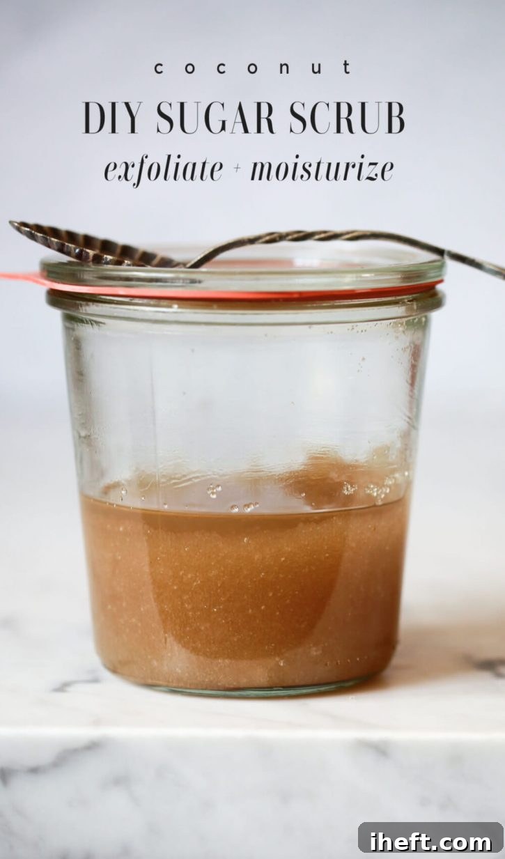A beautiful jar filled with a homemade coconut sugar scrub, ready to be used. A small spoon rests on top, and the label reads "Coconut Sugar Scrub: Exfoliating and Moisturizing."