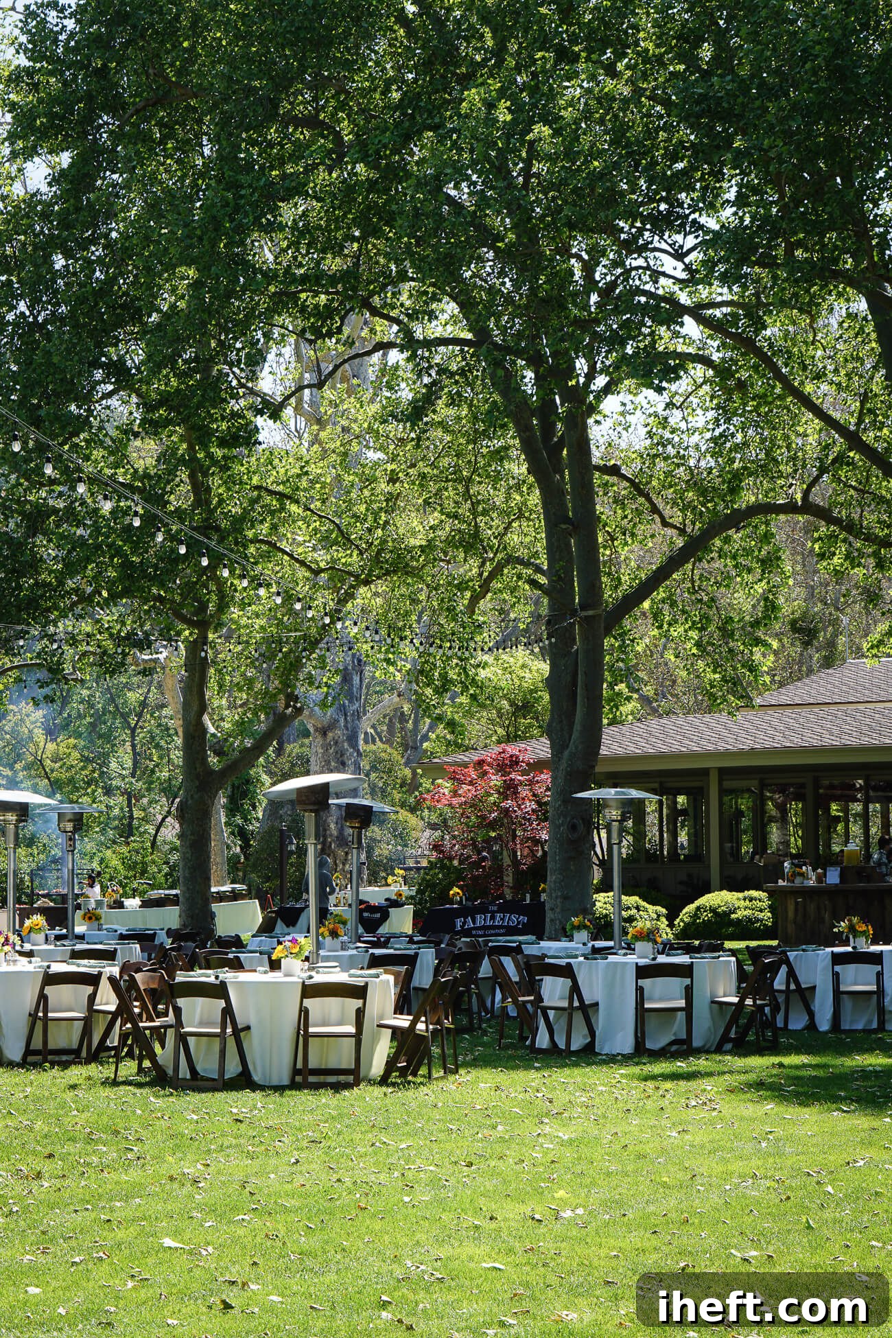 Round tables set on a lawn at Alisal Guest ranch in preparation for a luxury guest ranch grand BBQ. 