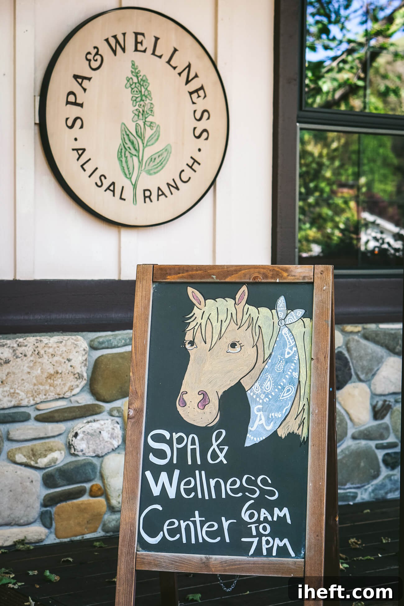 The entrance to the luxury Alisal Guest Ranch spa and wellness center with a chalkboard sign with a hand-drawn picture of a horse. 