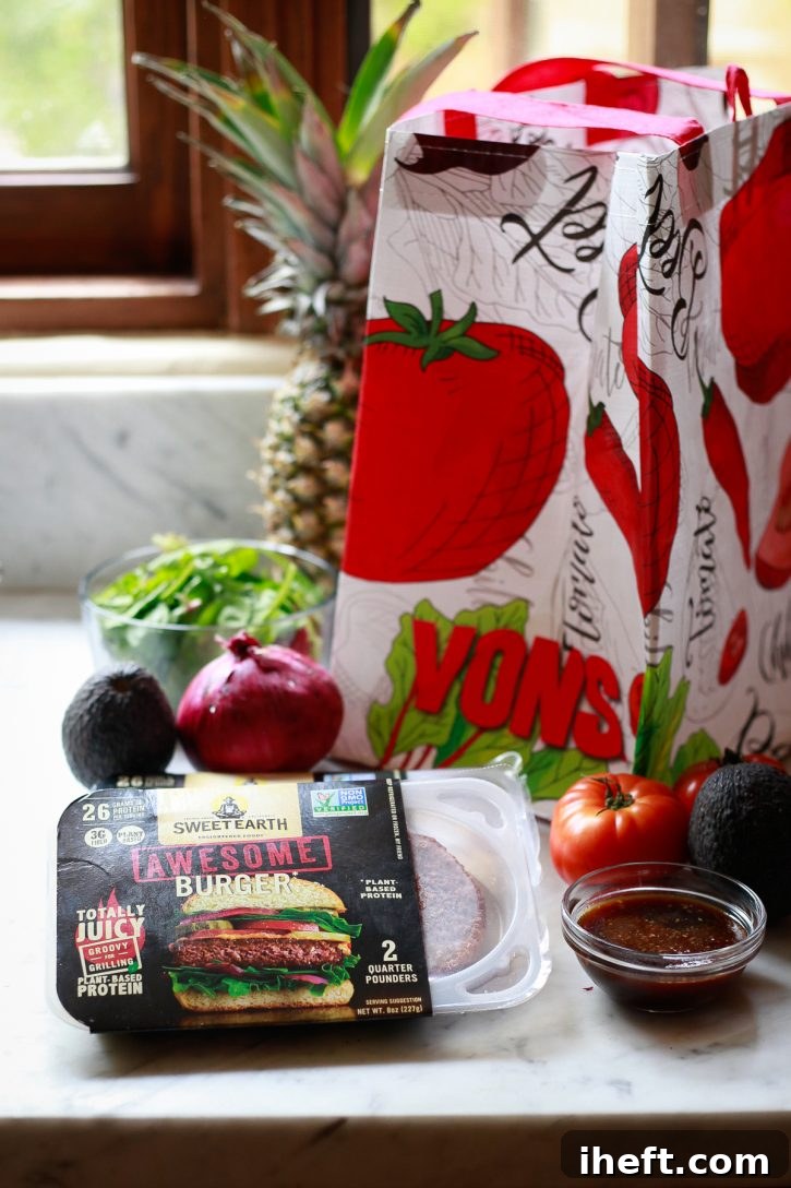 The ingredients for Hawaiian burgers sit on a countertop and include vegan patties from Sweet Earth.