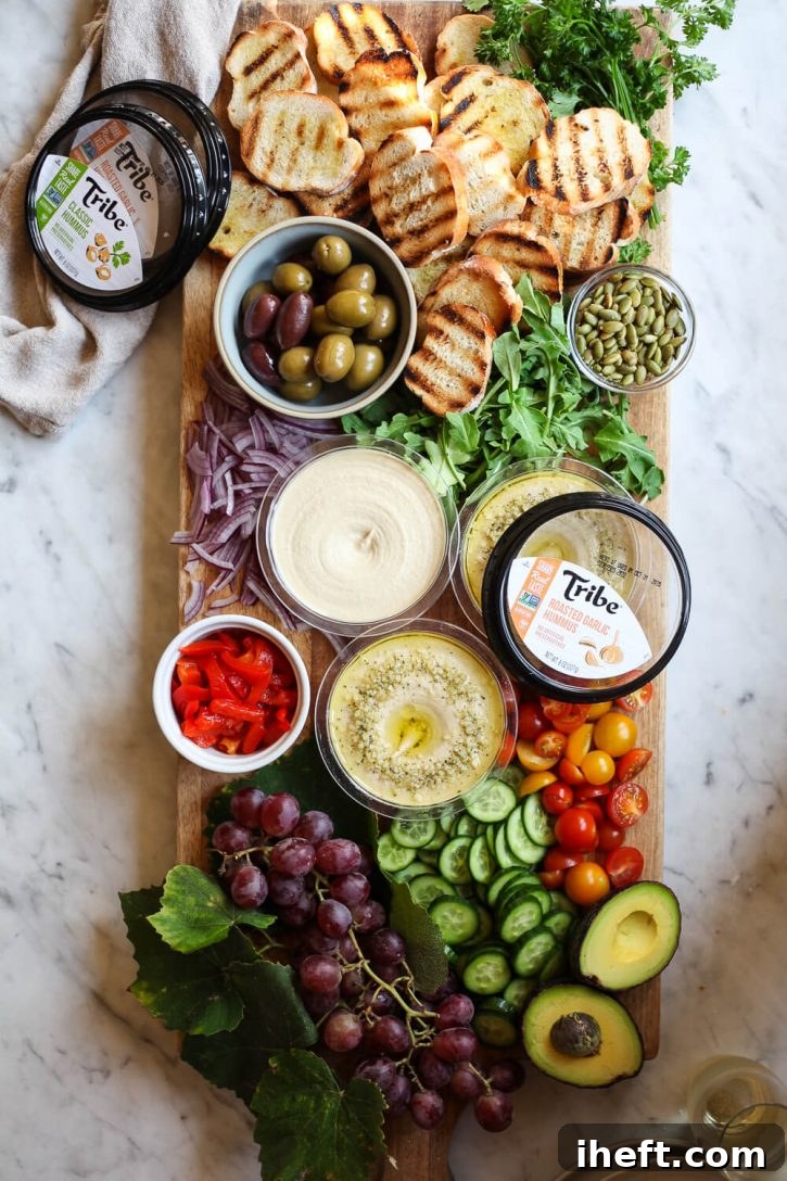 A stunning charcuterie board, artistically arranged with vibrant vegan ingredients like perfectly grilled crostini bread, creamy hummus, colorful bell peppers, crisp cucumber, juicy tomatoes, creamy avocado, and fresh arugula, showcasing the best easy and delicious vegetarian appetizers.