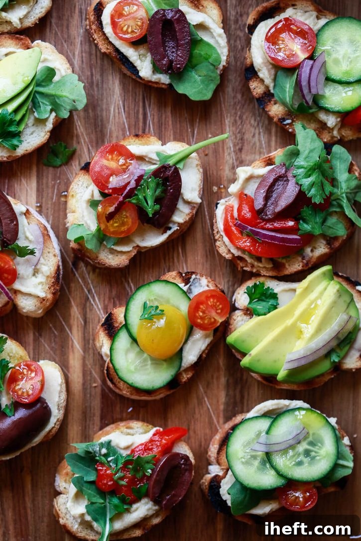 A close-up of beautifully plated, healthy crostini appetizers, generously topped with an assortment of Mediterranean ingredients. These crostini are celebrated as the best easy, delicious, and naturally vegetarian and vegan appetizers, perfect for any health-conscious gathering.