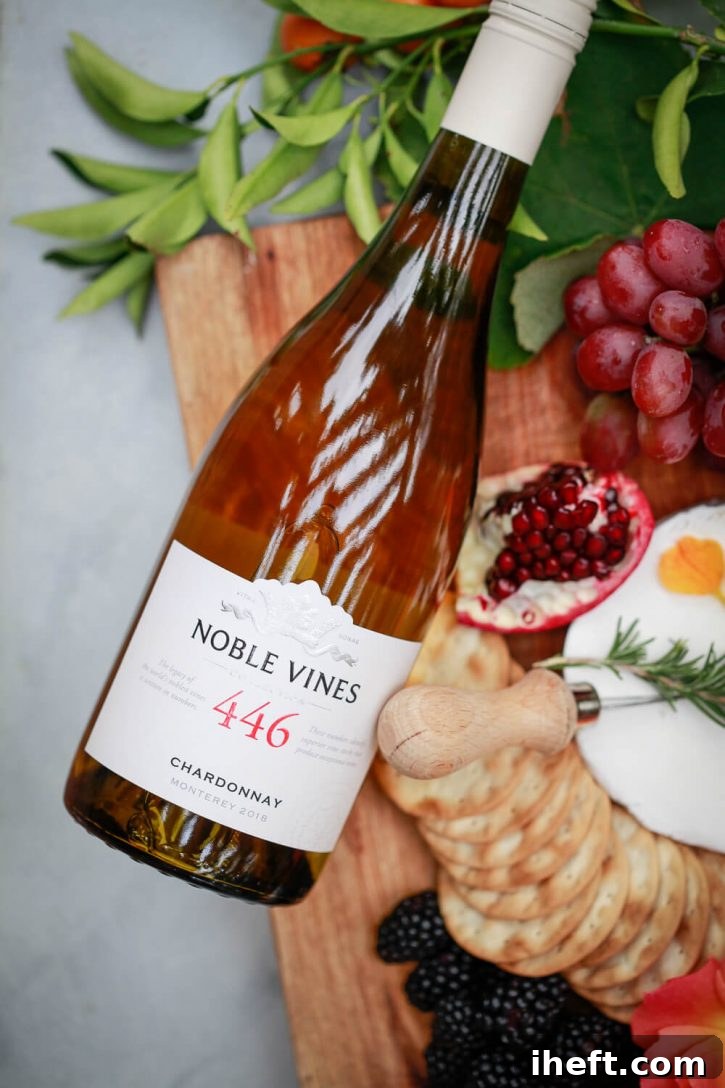 A close-up shot of a wine glass filled with red wine, artfully placed on an outdoor table alongside other glasses and a charcuterie board, ready for a sophisticated home wine tasting party.