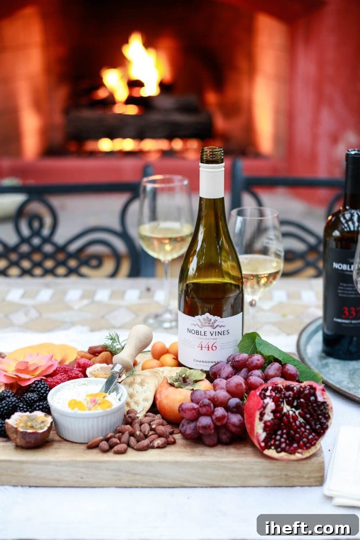 A final, elegant shot of the outdoor wine tasting setup with a bottle of wine, glasses, and the inviting charcuterie board, emphasizing the beautiful presentation of the event.