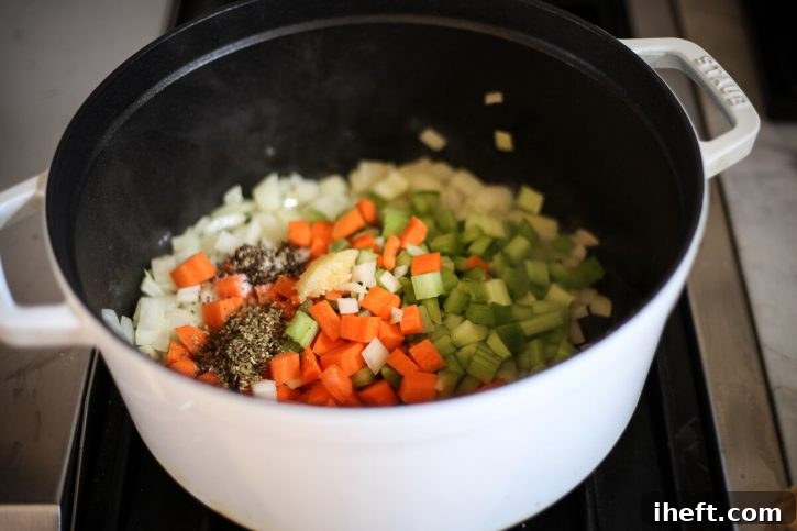 Diced onions, carrots, celery, garlic, salt and pepper in a soup pot to begin making soup. 