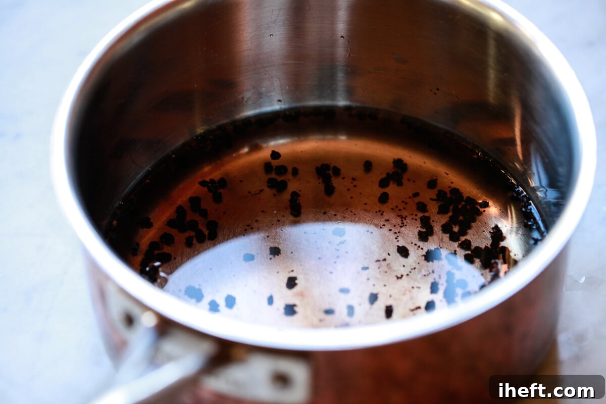 Water and dried elderberries in a saucepan.
