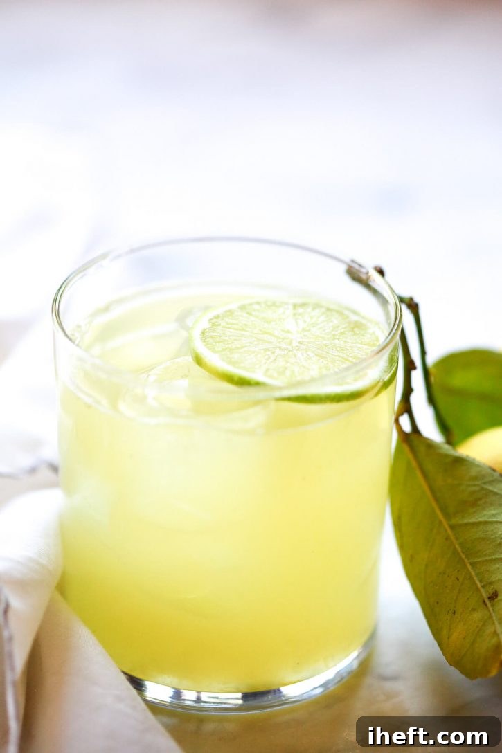 A captivating close-up photograph of a vibrant, freshly prepared margarita, expertly crafted with homemade margarita mix and premium tequila, shimmering with inviting appeal. 