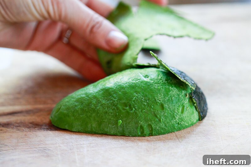 Half an avocado is peeled.
