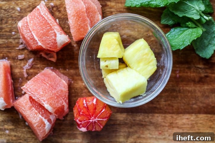 Peeled grapefruit, orange, pineapple and mint. 