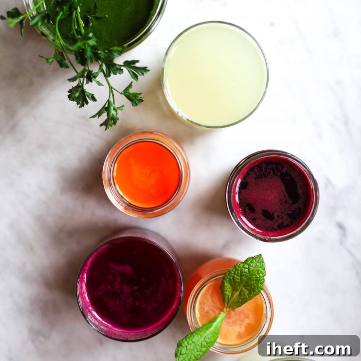 Six glasses of colorful freshly pressed juices.