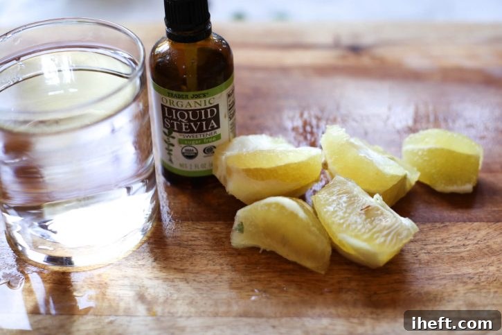 Peeled lemon, water, and liquid stevia ready to be juiced into a healthy detox drink. 