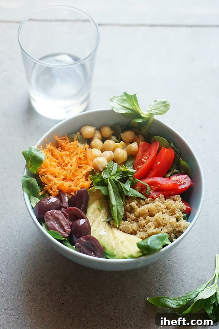 A quinoa bowl topped with chickpeas, tomatoes, carrots, olive, and basil is the perfect sugar detox lunch when you want to quit sugar. This vibrant and nutritious meal supports a healthy sugar-free diet.