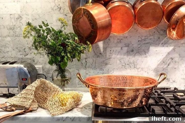 A beautiful photo of Mauviel copper pots and pans in a white kitchen. This is one of the safest non toxic cookware choices.