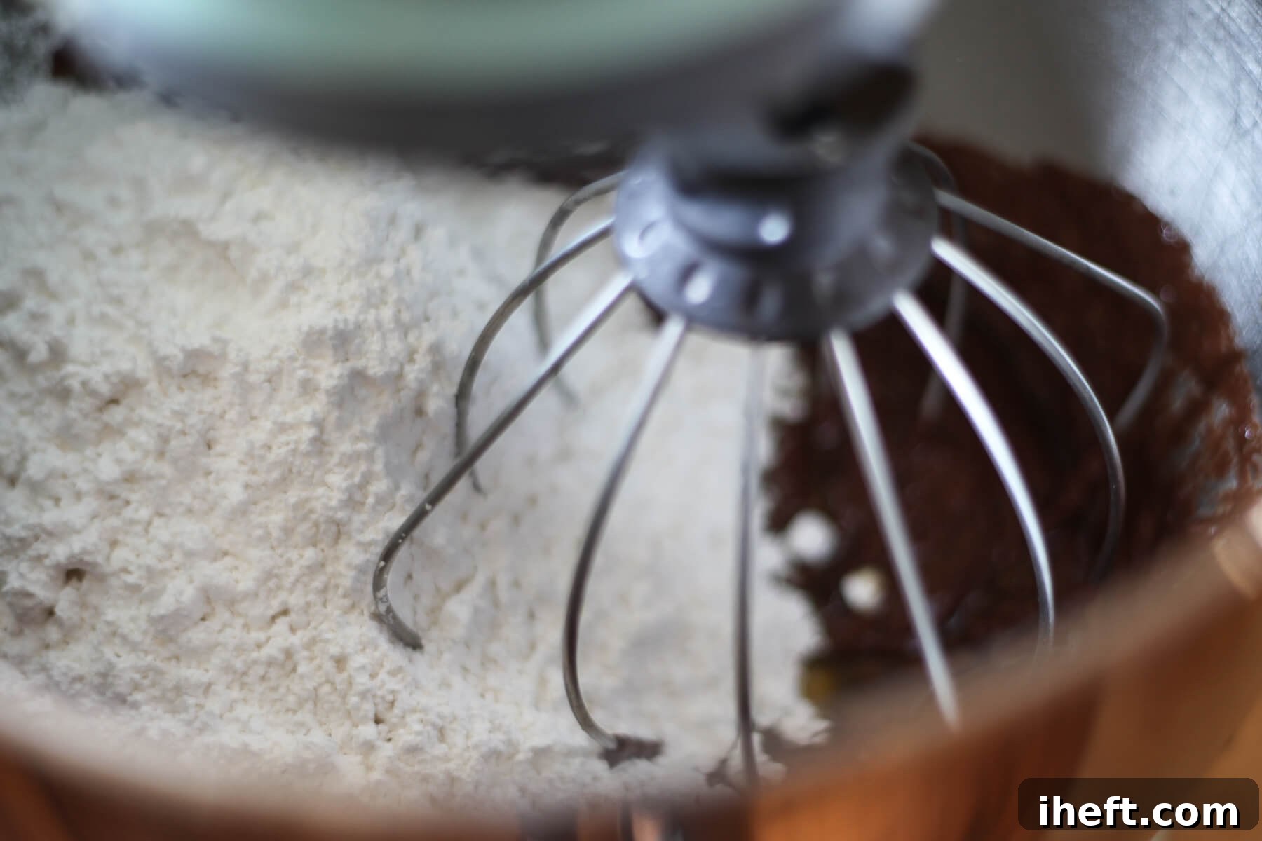 Powdered sugar, ganache, and vegan butter mix together in a mixer.