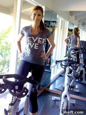 Woman wearing 'Never Give Up' shirt and Lululemon pants