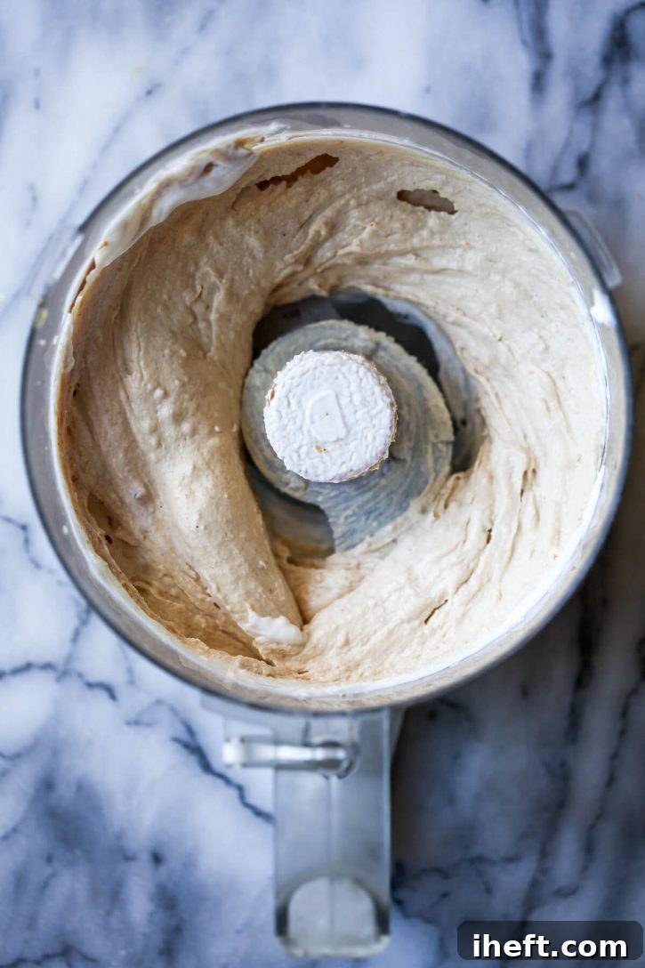 The blended mixture of yogurt, peanut butter, and banana, perfectly smooth and creamy, ready for portioning into individual dog ice cream treats.