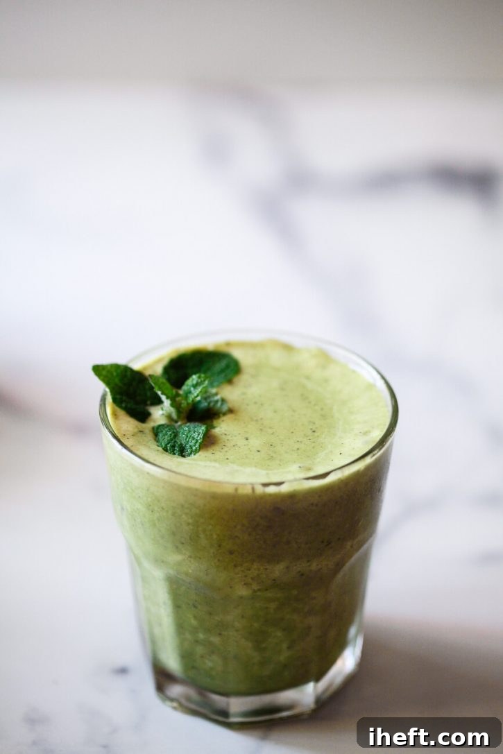 A close-up photo of a vibrant, healthy green protein shake, made with fresh mint leaves, promising a refreshing and nutritious experience.